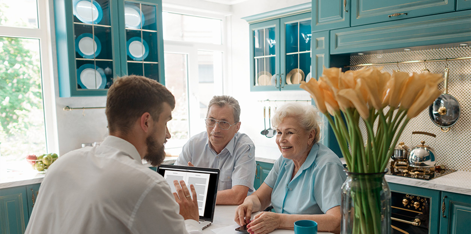 man having a meeting with elderly couple in their home